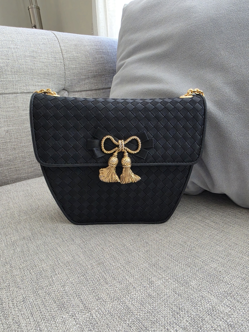 Black Woven Shoulder Bag with Gold Tassel Accent